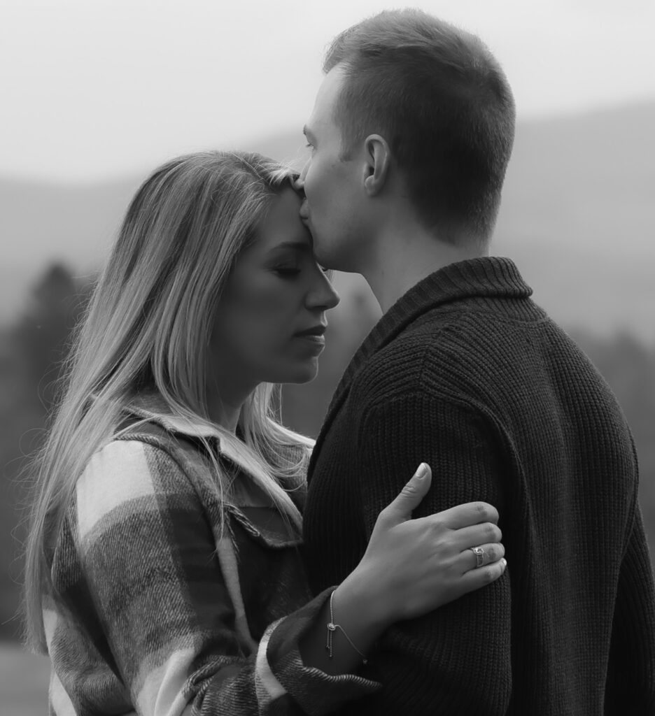 couple embracing in a kiss during their engagement photo shoot in Adamant, Vermont