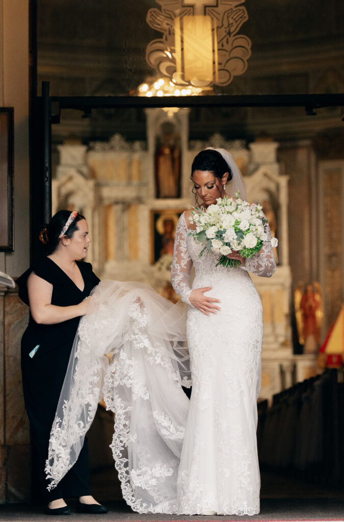 Bride and wedding photographer connecting on wedding day. Classic bride. Catholic wedding ceremony. 