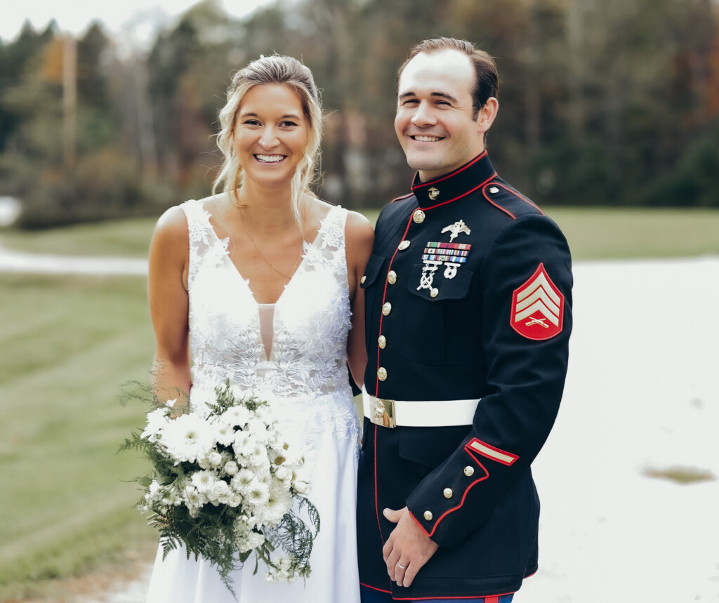 a couple poses for their wedding photos. Groom is a marine. Red Clover Inn, Vermont. 