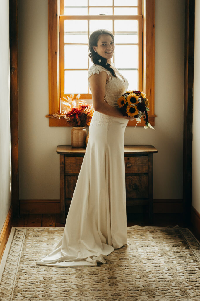 bride posing for bridal portraits during her fall wedding in Vermont. 