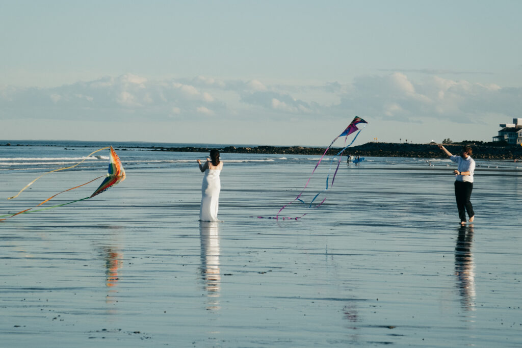 Couple flying kites during their elopement on the beach